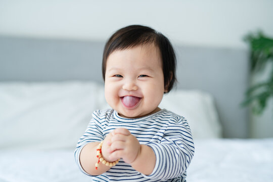 A 0 year old baby relaxing in the living room.