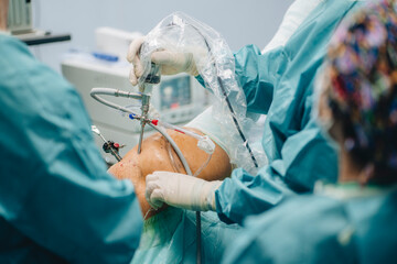 Surgeon with arthroscope operating patient