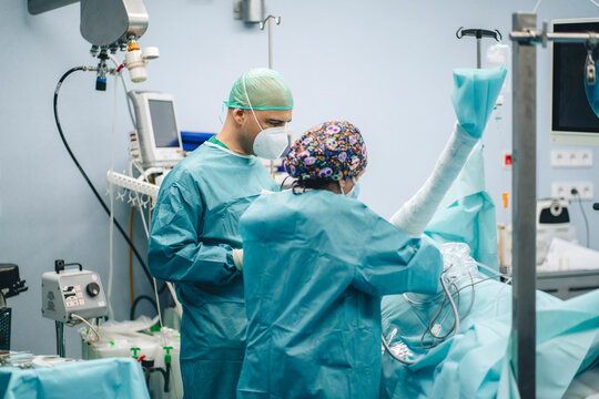 Surgeons with patient in operating room