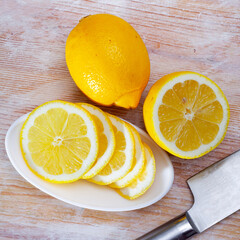 Lemon and knife on cutting board. High quality photo