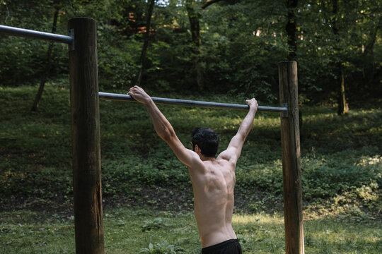 Young Man Exercising Outdoors In Nature on