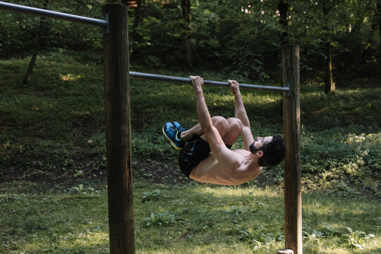 Young Man Exercising Outdoors In Nature on