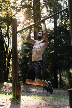 Young Man Exercising Outdoors In Nature on