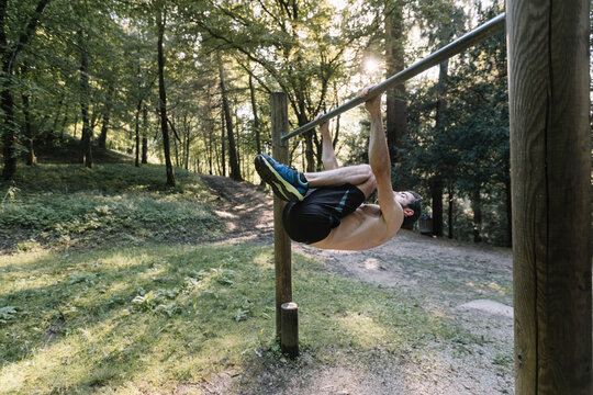 Young Man Exercising Outdoors In Nature on