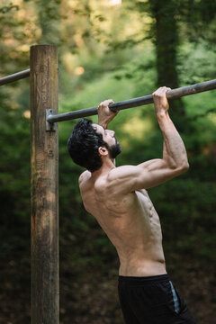 Young Man Exercising Outdoors In Nature on
