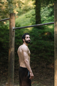 Young Man Exercising Outdoors In Nature on