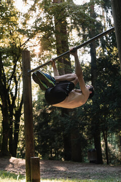 Young Man Exercising Outdoors In Nature on