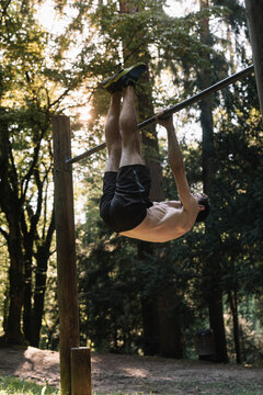 Young Man Exercising Outdoors In Nature on