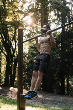 Young Man Exercising Outdoors In Nature on