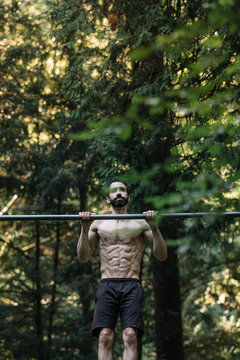 Young Man Exercising Outdoors In Nature on
