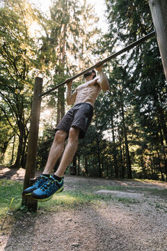 Young Man Exercising Outdoors In Nature on