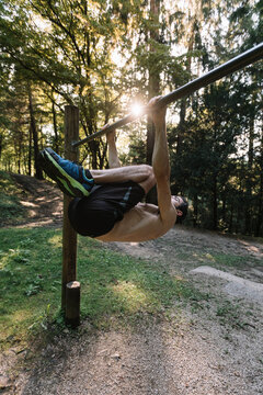 Young Man Exercising Outdoors In Nature on