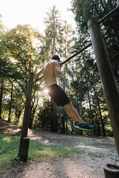 Young Man Exercising Outdoors In Nature on
