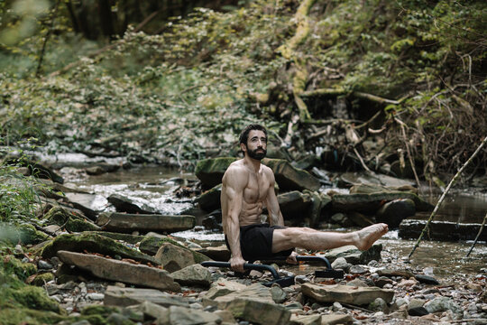 Young Man Exercising Outdoors In Nature