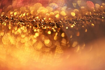 Christmas background. Glowing bokeh. Shining background. Festive Background. gold glitter texture.soft focus.Beautiful bokeh background in gold colors.Glowing bokeh.