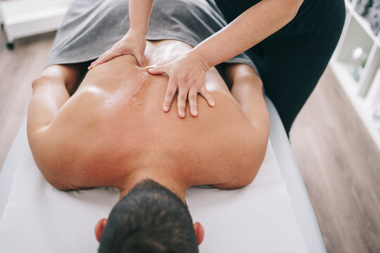 Doctor kneading back of patient during appointment
