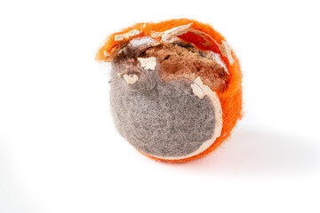 A tennis ball or a chewed up dog toy on a white background. - 473645205