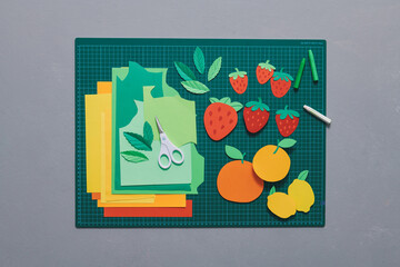 Creative summer paper fruits on cut board