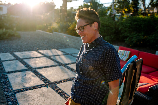 Happy woman standing in sunshine