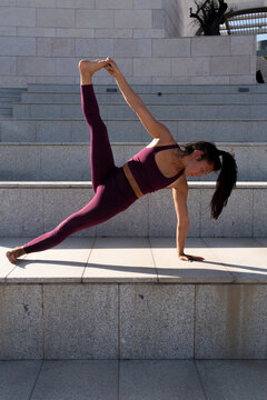 Holding the foot with the fingers on a yoga practice