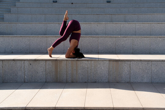Woman practising Asana yoga outdoors