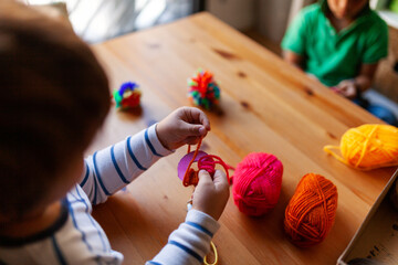 Children making crafts with wool