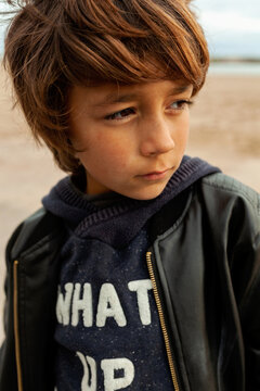 Young boy with leather jacket at the beach
