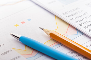 Accounting document with pencil and checking financial chart. Concept of banking, financial report and financial audit.