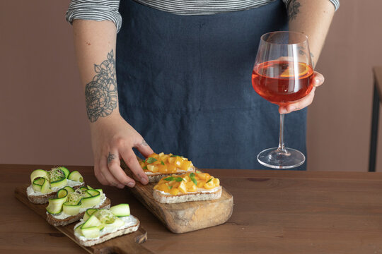 Woman Having Aperitif With Finger Food