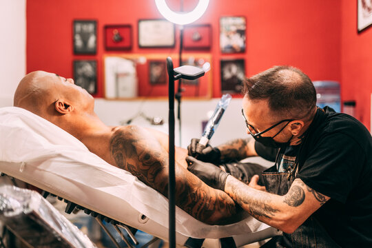 Tattoo artist working at his studio