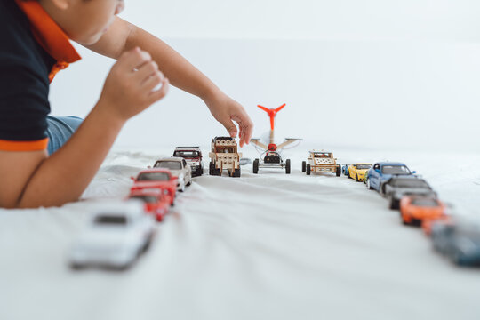 Child playing Boy plays with toy cars