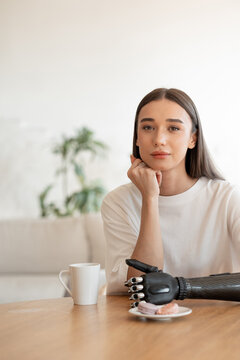 Woman with a cup of coffee and a cookie 