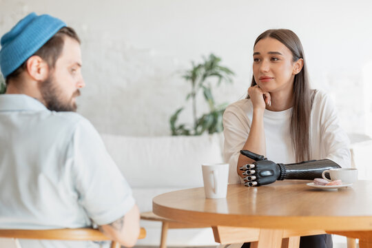 Young woman and young man having coffee together
