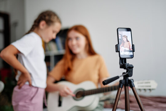 Blur of cheerful girls studying and live streaming 
