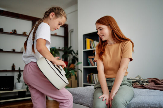 Female pupil playing on instrument  at home 