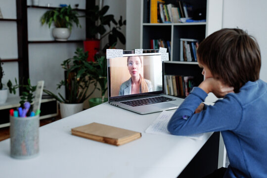 Young boy concentrated on online lesson