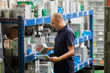 Male mechanic in storage of factory