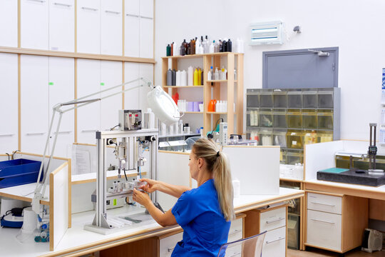 Scientist checking bottles during quality control