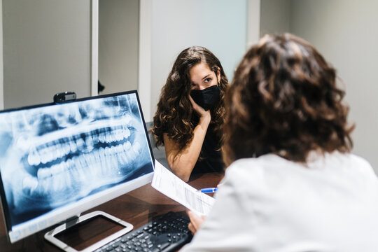Dentist and patient checking documents