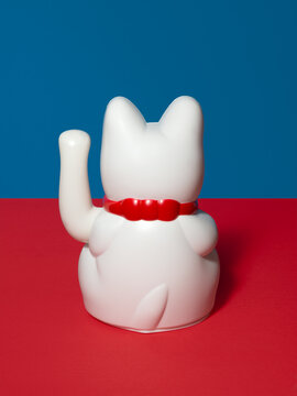 Still life with a back turned maneki neko toy