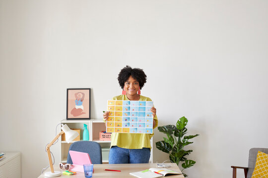 Cheerful designer with draft in office