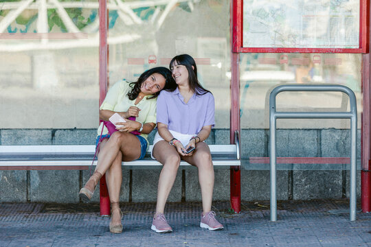 Mother and teenage daughter waiting at metro station