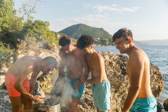 Friends preparing barbecue at the beach