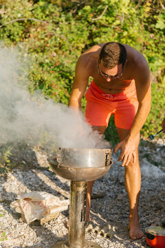 Friends preparing barbecue at the beach