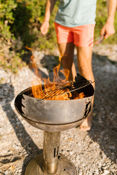 Friends preparing barbecue at the beach