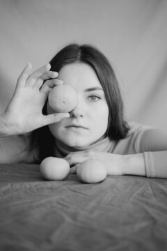 Woman Covering Her Eye With Mandarin