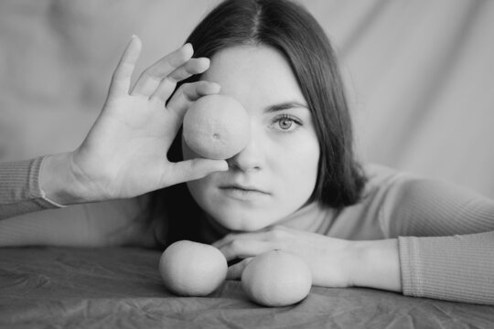 Woman Covering Her Eye With Mandarin