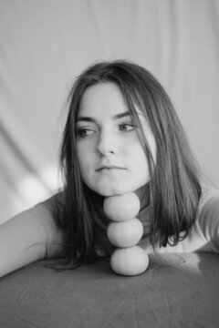 Woman Leaning Her Face On Mandarins 
