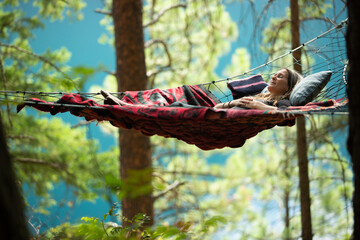 Woman relaxing in hammock in nature