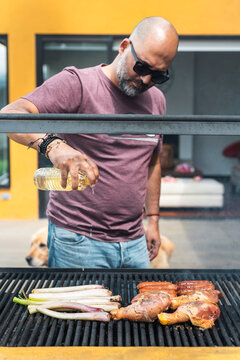 Hispanic family man preparing bbq